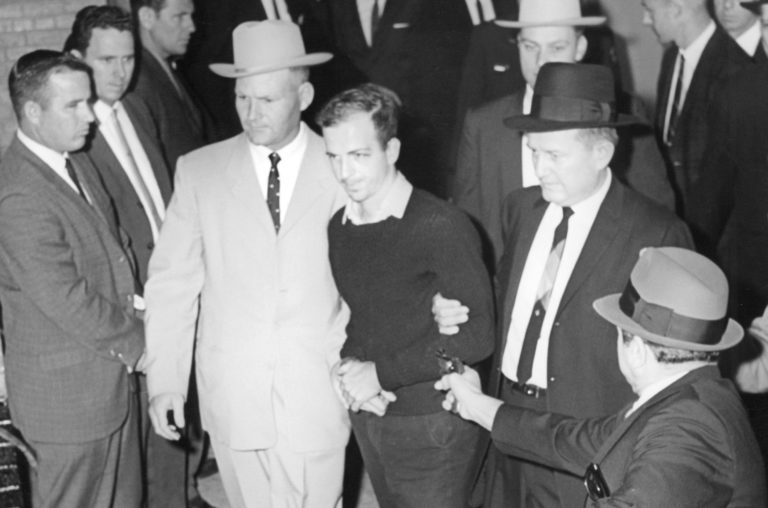 Lee_Harvey_Oswald_being_shot_by_Jack_Ruby_as_Oswald_is_being_moved_by_police_1963-e15671834936...jpg