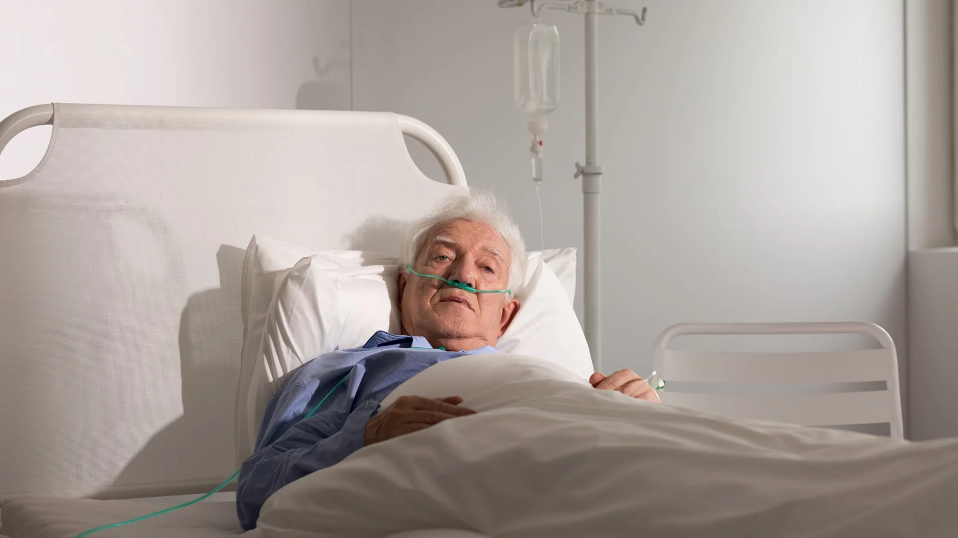 old guy in some bed.webp